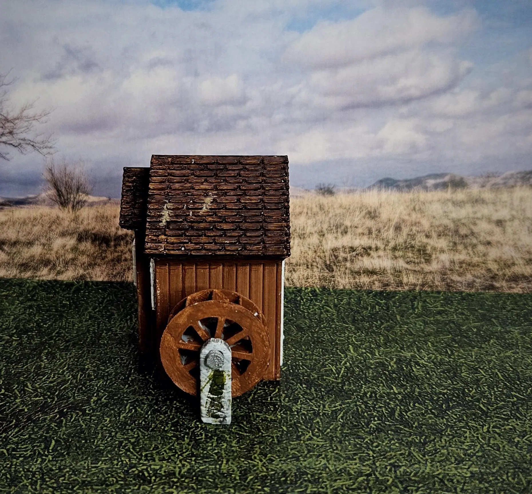 Side view of HO scale waterwheel with medium building